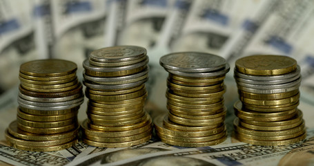 Stacks of coins on a background of dollars. The concept of business and finance.
