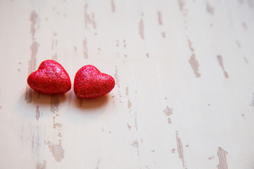 two red hearts on a shabby white background closeup