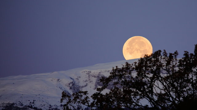 Supermoon full moon over the Jura mountains between Switzerland and France