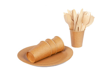 Crockery made from eco kraft paper, paper cups, dishes, bag, fast food containers isolated on white background. Recycling concept. Zero waste. Close-up...