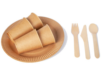 Crockery made from eco kraft paper, paper cups, dishes, bag, fast food containers isolated on white background. Recycling concept. Zero waste. Close-up...
