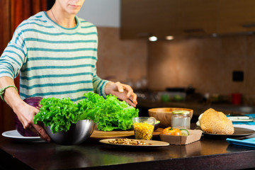 Woman prepares a vegetarian recipe in the kitchen
