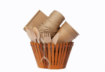 Crockery made from eco kraft paper, paper cups, dishes, bag, fast food containers isolated on white background. Recycling concept. Zero waste. Close-up...