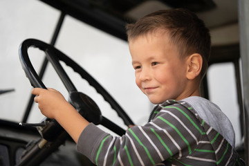 Boy driving in the cab of a truck