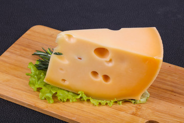 Maasdam cheese  in the board served salad leaves
