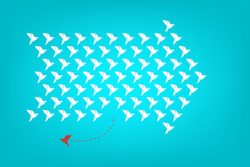 Think differently - One red unique different paper bird flying opposite way of identical white ones. 