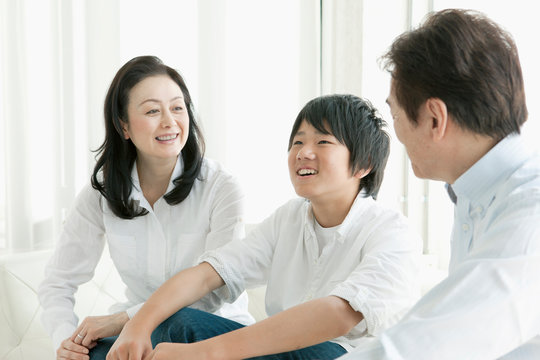 Smiling parents with son in living room