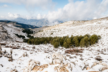 impressive background of a snowy mountain at sunset with dense clouds with lots of color