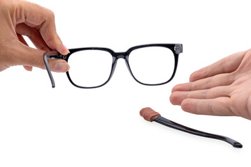 Hand holding Broken eyeglasses first-person view isolated on white background.