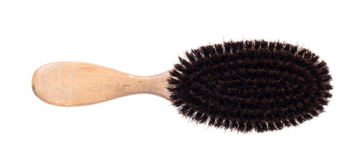 Old hair brush with some hair in it