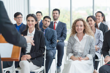 Group of diverse audience  listening to business coach at business meeting and training seminar to...