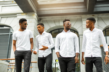 four handsome young african men in white shirts