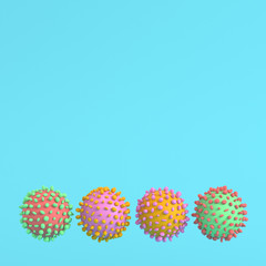 Four colorful viruses on bright blue background in pastel colors. Minimalism concept