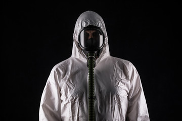 man in gas mask and in white overalls
