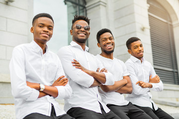 Fototapeta na wymiar four handsome young african men in white shirts