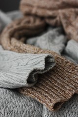 Obraz na płótnie Canvas Beautiful knitted grey and brown sweaters macro