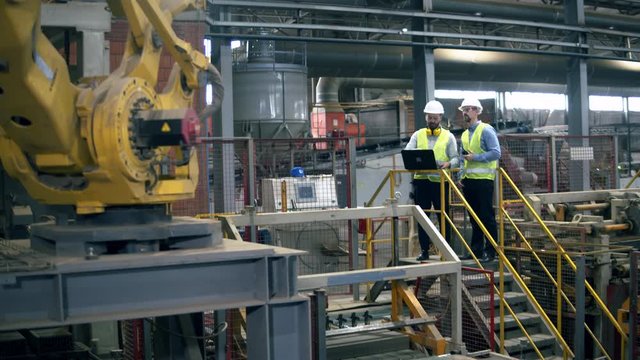 Mechanical plant unit and male engineers supervising it