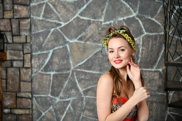 beautiful pin-up girl in a gray-red dress posing in different poses