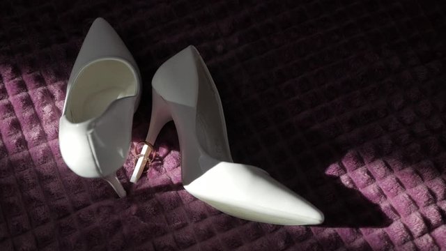 Wedding rings on the bride's shoes. Wedding. Decor. Bride's shoes.