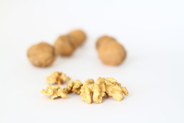 Peeled walnut closeup. Golden walnut kernel on a white background. Healthy foods.