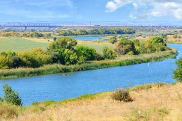 Obraz premium View of the Southern Bug River and the railway bridge on the horizon.