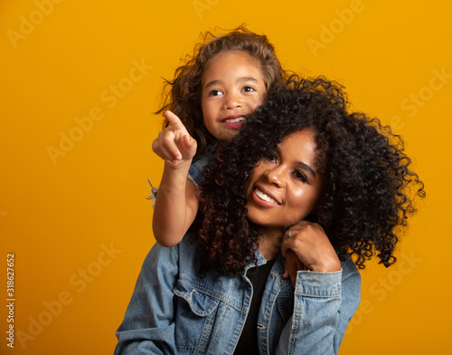 happy mother's day! Adorable sweet young afro-american mother with cute little daugh.