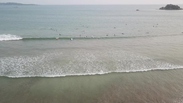 Aerial view of the Weligama bay and many surfers at sunrise. Sri Lanka aerial view