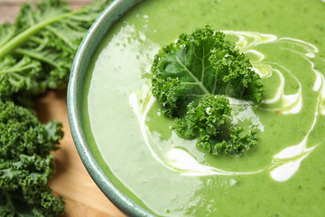 Fototapeta premium Tasty kale soup with cream on table, closeup