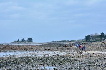 Pensioner hikers on a path on the coastline in Brittany. France