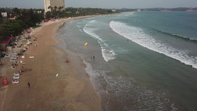 Aerial view of the Weligama bay and many surfers at sunrise. Sri Lanka aerial view