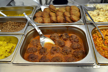 Meat dishes on the food distribution line in the self-service dining room