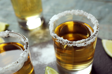 Mexican Tequila shots with salt on table, closeup