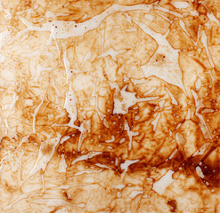 Background texture of a polyethylene transparent film with brown liquid streaks
