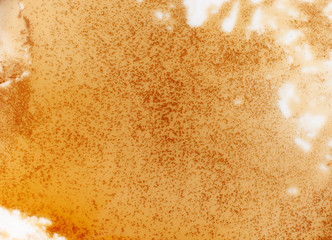 Background texture of a spilled brown liquid with splashes