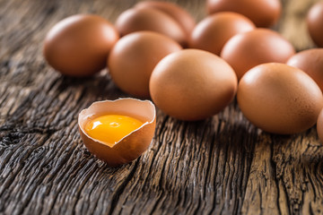 Fresh raw eggs on rustic wooden table