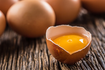 Fresh raw eggs on rustic wooden table