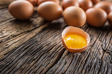 Fresh raw eggs on rustic wooden table