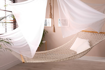 Comfortable hammock in stylish room. Interior design © New Africa