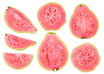 Isolated cut guava fruits. Pieces of green pink fleshed guavas isolated on white background with...