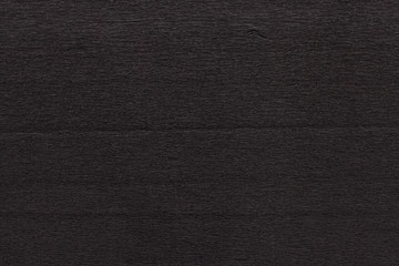 Texture of dark black corrugated thin uneven paper