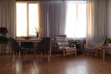 Windows with stylish curtains in living room interior