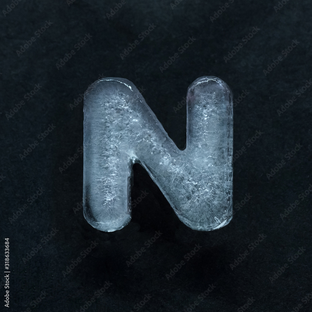 Fototapete melting speech. alphabet's shiny and well-structured letters made out of ice isolated on dark studio