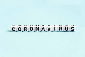 Coronavirus word written on blocks on blue background. New rapidly spreading virus from China (Wuhan). Corona virus 2019-nCoV, MERS-CoV