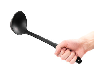 Hand holding a black plastic ladle. Close up. Isolated on a white background