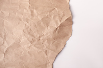 Fototapeta na wymiar Crumpled recycled paper with a torn edge on a white background