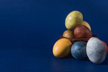  Multi-colored bright easter eggs. Easter. Easter eggs on a dark blue background Easter background. Easter symbol Easter greetings Christ is risen Copyspace close-up