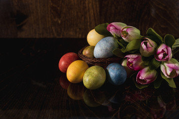 Multi-colored bright easter eggs. Easter. Easter eggs on a dark wooden background Easter background. Easter symbol Easter greetings Christ is risen Copyspace close-up