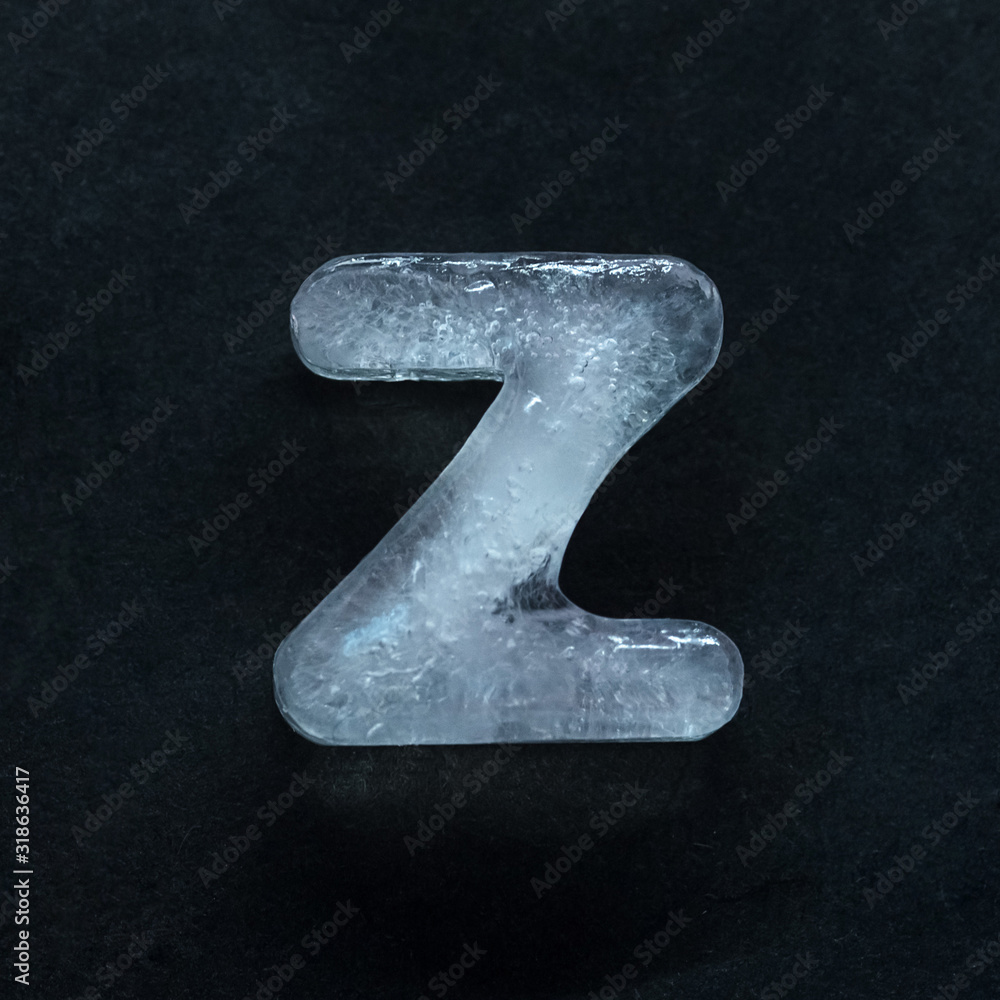 Fototapete melting speech. alphabet's shiny and well-structured letters made out of ice isolated on dark studio