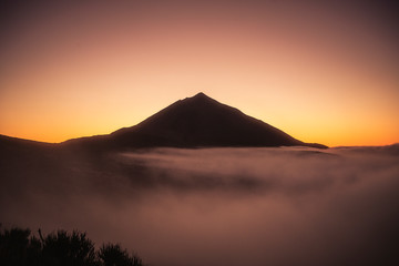 Fototapeta na wymiar Beautiful view landscape of sunset or sunrise of el teide vulcan with clouds and foreground nature