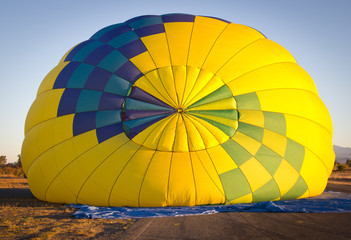 Fototapeta premium Colorful hot air balloon view from the top during inflating. 